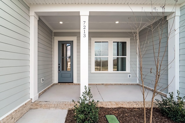 view of exterior entry with a porch