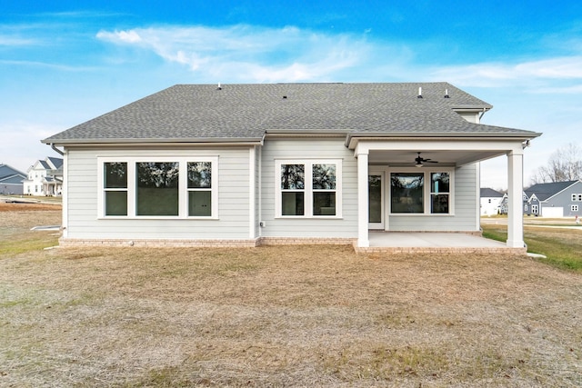 rear view of house with a patio, ceiling fan, and a lawn