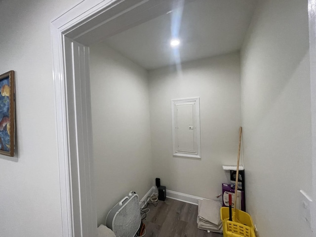 laundry area with electric panel and dark hardwood / wood-style floors