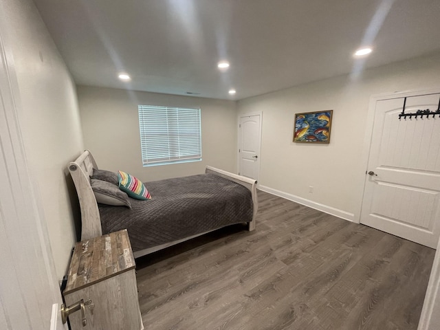 bedroom with dark hardwood / wood-style floors