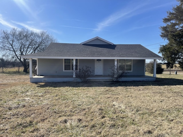 view of front of house featuring a front lawn and covered porch