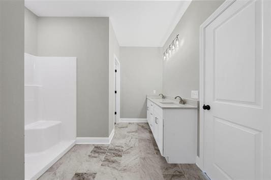 bathroom featuring vanity and a shower