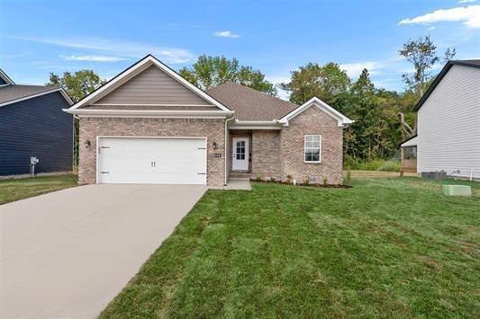 view of front of property featuring a garage and a front yard