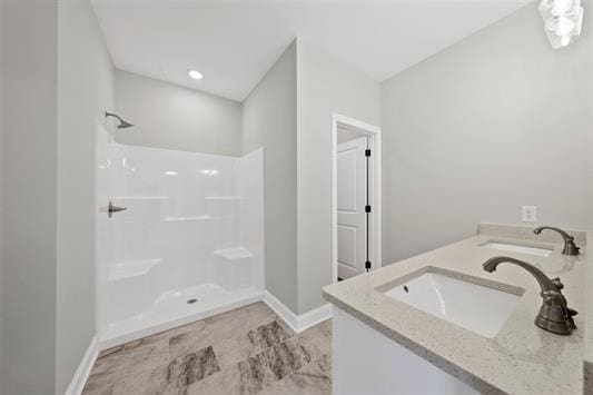 bathroom featuring vanity and a shower