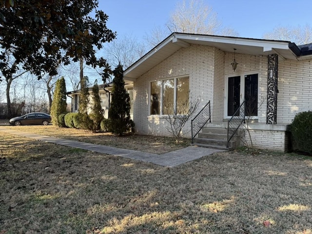 view of property exterior featuring a lawn