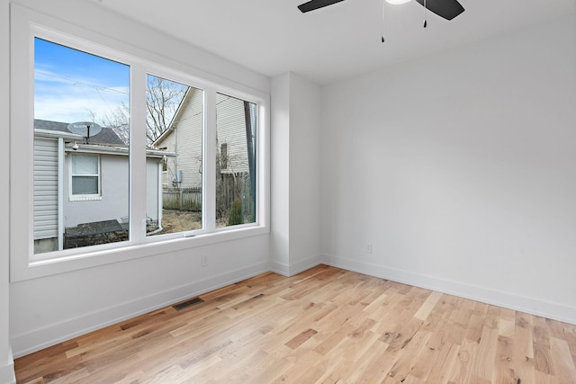 unfurnished room with light hardwood / wood-style flooring and ceiling fan