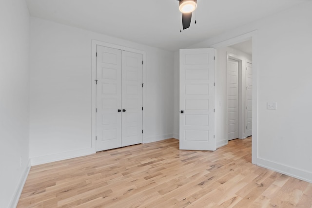 unfurnished bedroom with a closet, ceiling fan, and light wood-type flooring