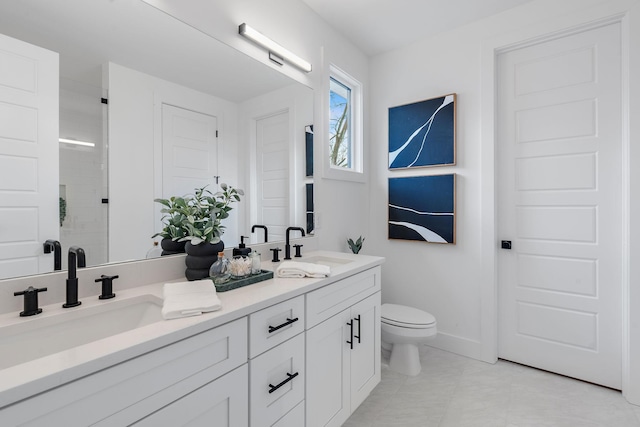 bathroom featuring tile patterned floors, vanity, toilet, and a shower with door