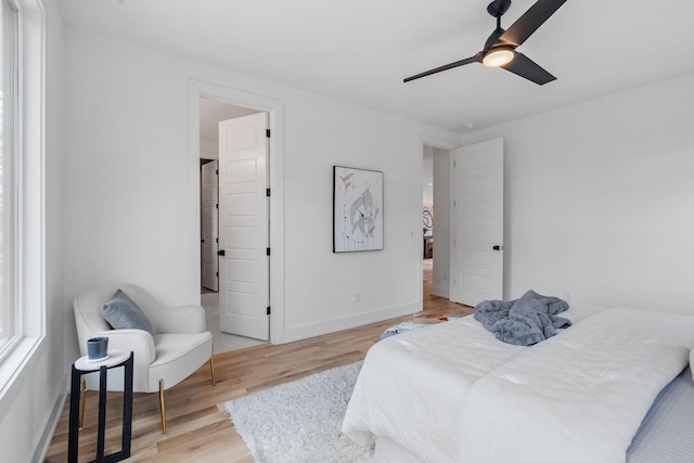 bedroom with light hardwood / wood-style flooring and ceiling fan