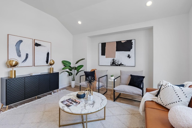 living room featuring vaulted ceiling and light wood-type flooring