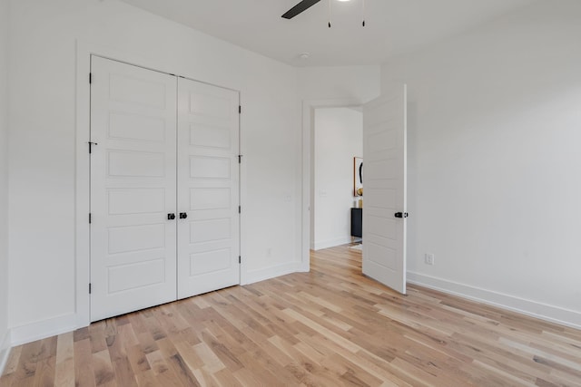 unfurnished bedroom featuring a closet, ceiling fan, and light hardwood / wood-style flooring