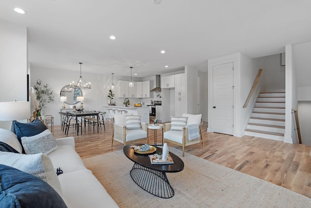 living room featuring a chandelier and light hardwood / wood-style floors