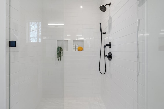 bathroom with a tile shower