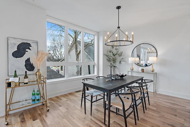 dining area with a chandelier and light wood-type flooring