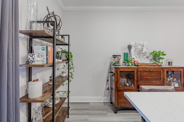 interior space featuring ornamental molding and wood-type flooring