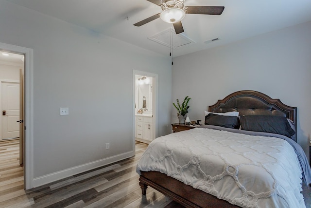 bedroom with connected bathroom, hardwood / wood-style flooring, and ceiling fan