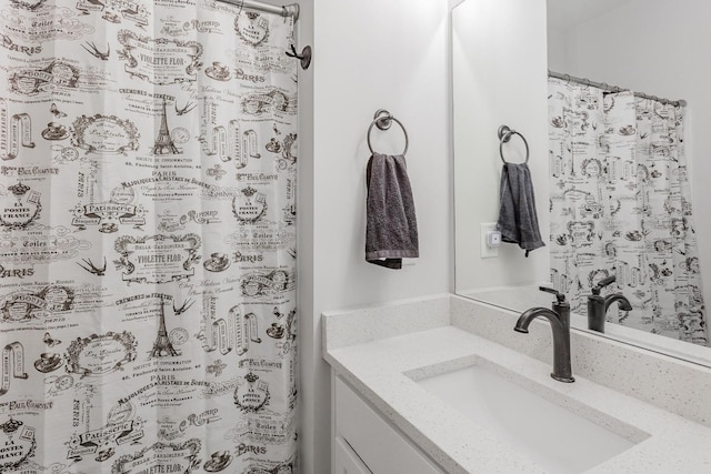 bathroom with walk in shower and vanity