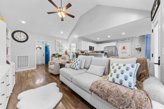 living room with ceiling fan, dark wood-type flooring, and high vaulted ceiling