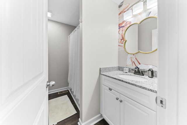 bathroom featuring vanity and wood-type flooring