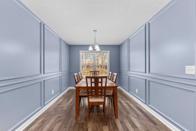 dining space featuring an inviting chandelier and dark wood-type flooring