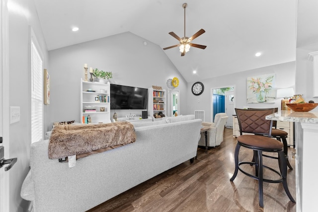 living room with dark wood-type flooring, high vaulted ceiling, and ceiling fan