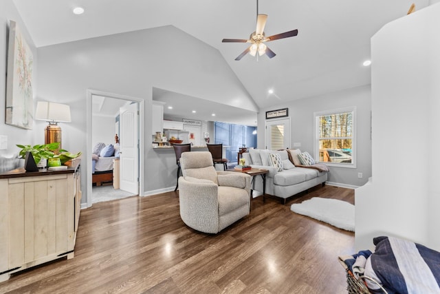 living room featuring wood-type flooring, ceiling fan, and high vaulted ceiling