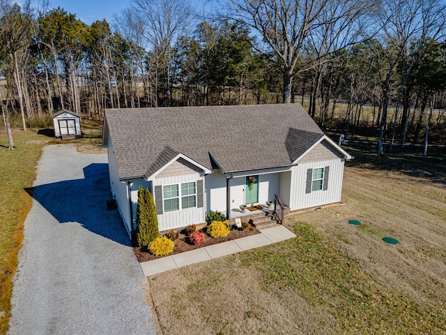 ranch-style house with a front lawn and a shed