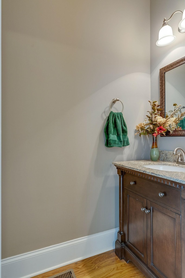 bathroom featuring vanity and hardwood / wood-style floors