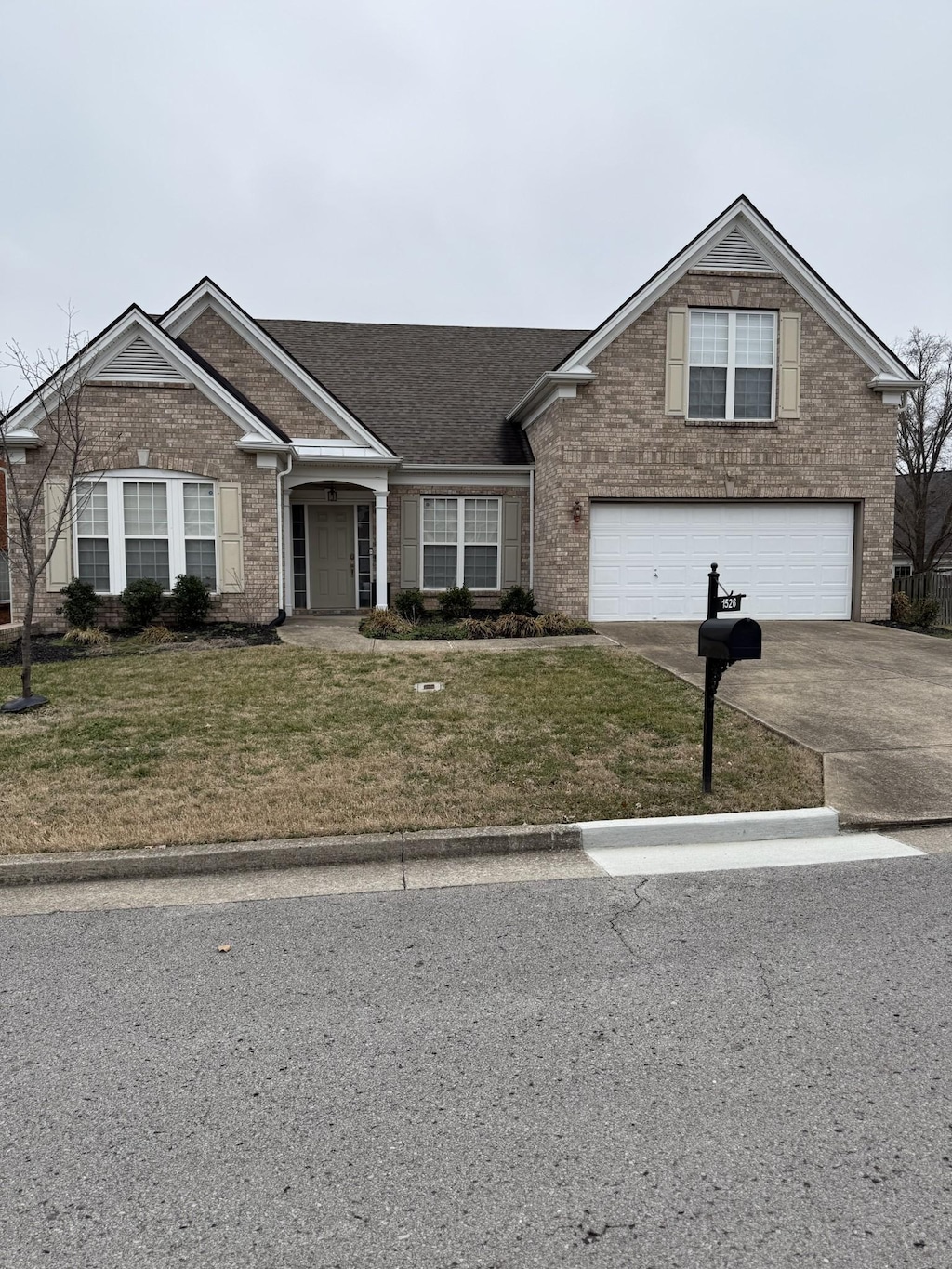 view of front of house featuring a garage and a front lawn