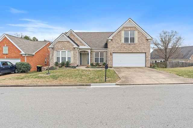 view of front of house with a garage and a front lawn