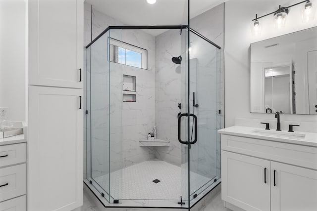 bathroom with vanity and an enclosed shower