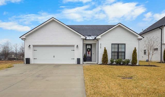 view of front of house featuring a garage and a front lawn