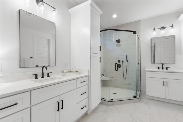 bathroom with vanity and a shower with shower door