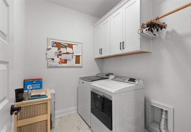 washroom with cabinets and washer and clothes dryer