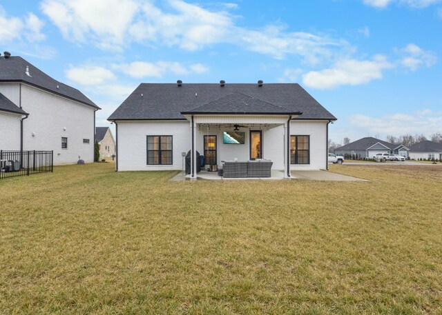 back of property with a patio, an outdoor hangout area, a yard, and ceiling fan