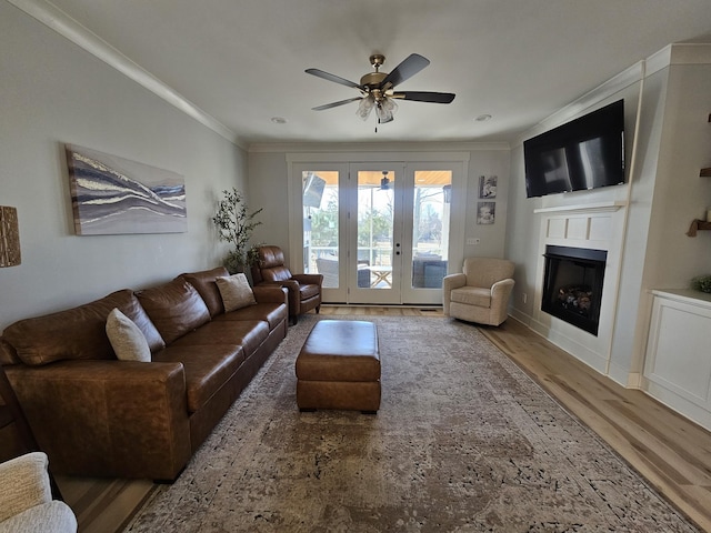 living room with crown molding, hardwood / wood-style floors, and ceiling fan