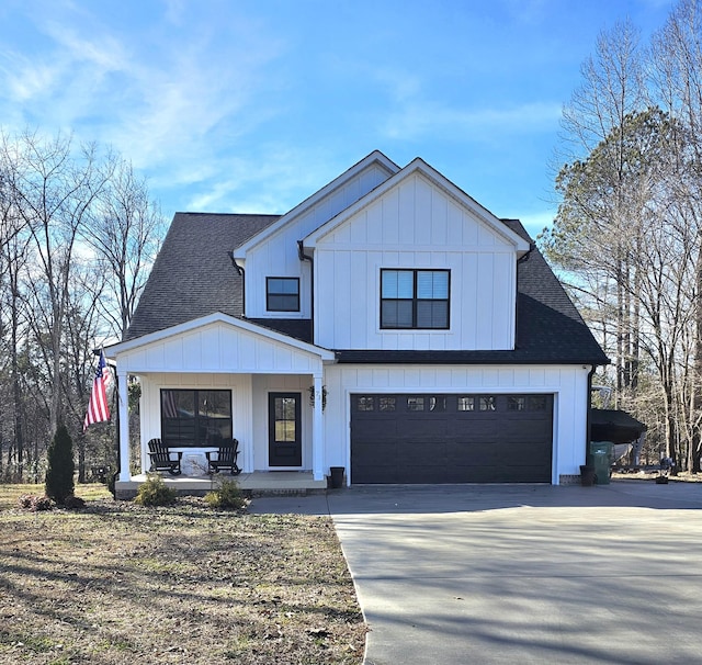 modern farmhouse featuring a porch and a garage