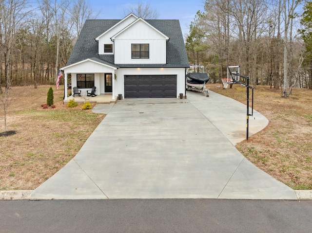 modern inspired farmhouse featuring a garage, a front yard, and covered porch