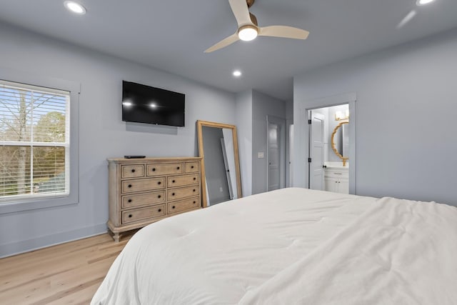 bedroom with ceiling fan, ensuite bath, and light hardwood / wood-style flooring