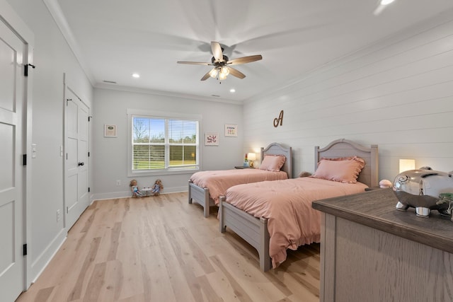 bedroom featuring crown molding, ceiling fan, and light hardwood / wood-style floors