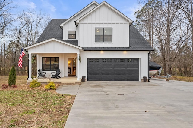 modern inspired farmhouse featuring a porch and a garage