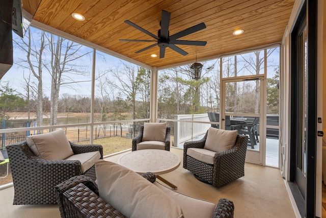 sunroom / solarium featuring ceiling fan and wood ceiling