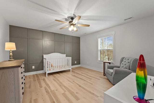 bedroom with ceiling fan and light wood-type flooring