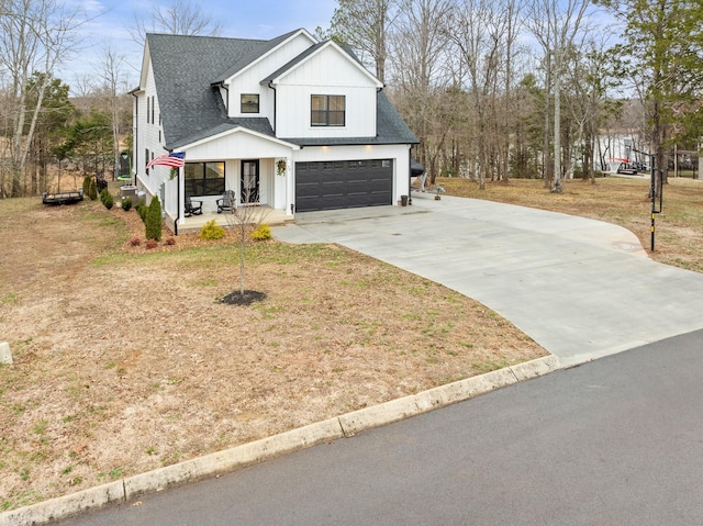 modern farmhouse style home featuring a garage, covered porch, and a front yard