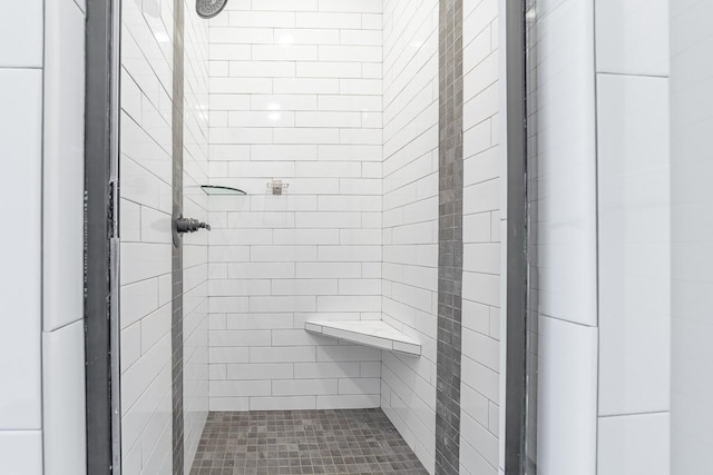 bathroom with tiled shower