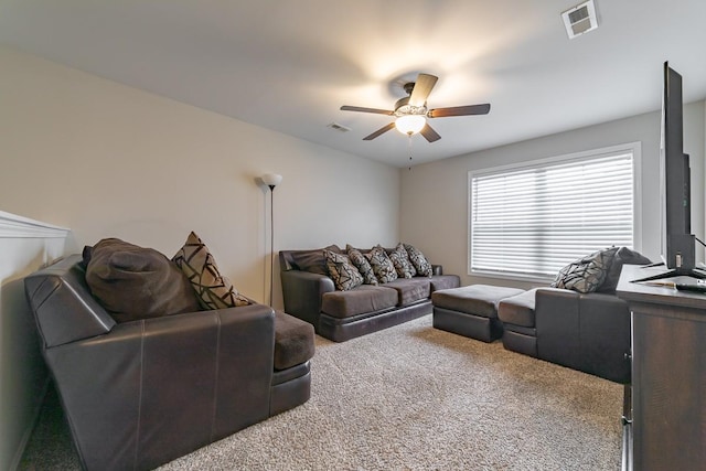 carpeted living room featuring ceiling fan