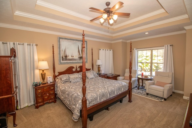 carpeted bedroom featuring crown molding, a raised ceiling, and ceiling fan