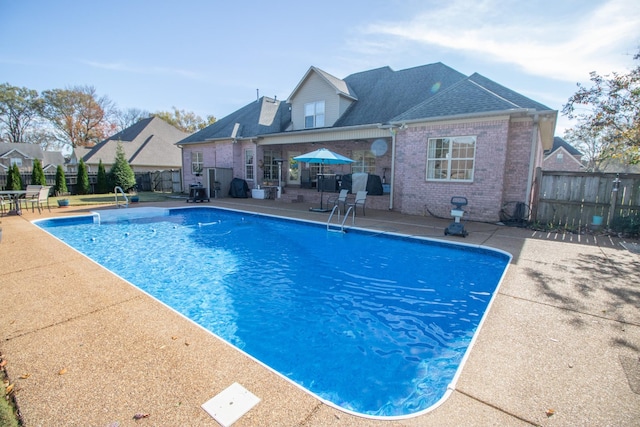 view of swimming pool featuring a patio area