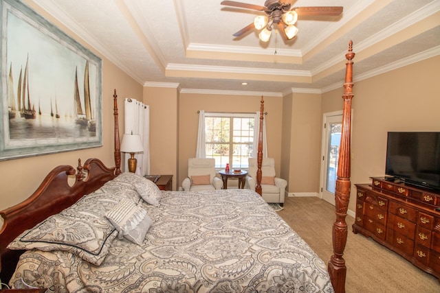 carpeted bedroom featuring crown molding, ceiling fan, and a tray ceiling