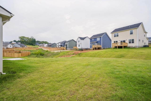 view of yard featuring a residential view and a wooden deck